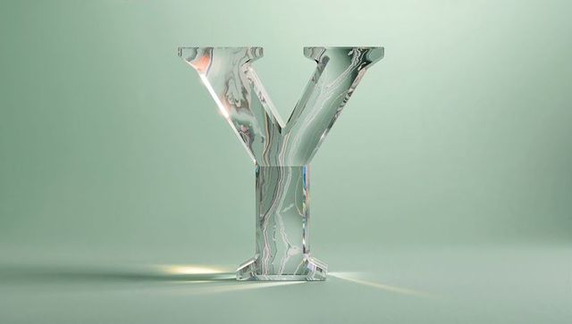 Standing glass-like letter y with swirled green marbled pattern