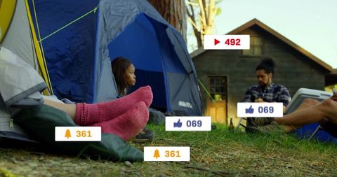 Friends Relaxing with Social Media Overlay in Forest Campsite