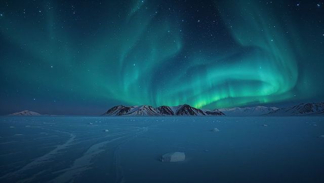 Dancing Northern Lights Over Frozen Arctic Plains and Snow-Capped Mountain Silhouettes
