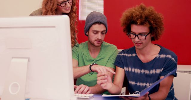 Young Creative Team Collaborating Around Computer in Modern Office - Download Free Stock Images Pikwizard.com