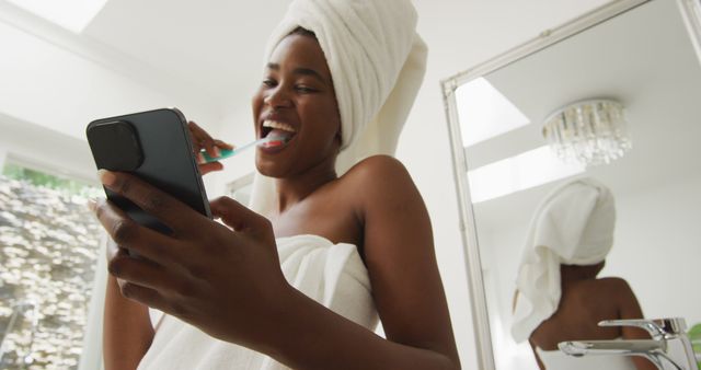 Happy Woman Brushing Teeth and Using Smartphone in Morning Routine - Download Free Stock Images Pikwizard.com