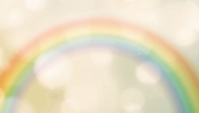 Pastel rainbow arch over cream bokeh creating dreamy ethereal soft-light atmosphere