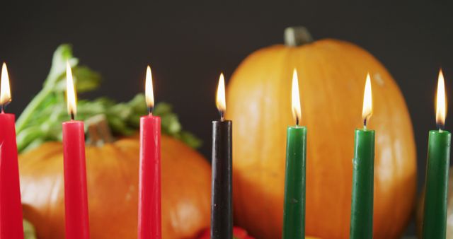Composition of seven lit candles and halloween pumpkins. halloween tradition and celebration concept digitally generated image.