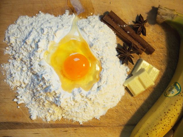 Baking Ingredients on Wooden Board with Egg, Flour, Banana and Spices - Download Free Stock Photos Pikwizard.com