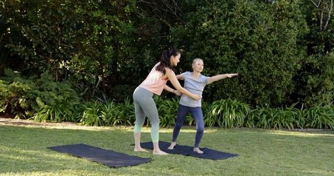senior woman practicing yoga with professional trainer outdoors - Download Free Stock Images Pikwizard.com