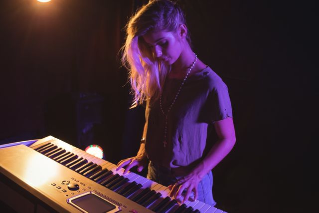 High angle view of female musician playing piano in nightclub
