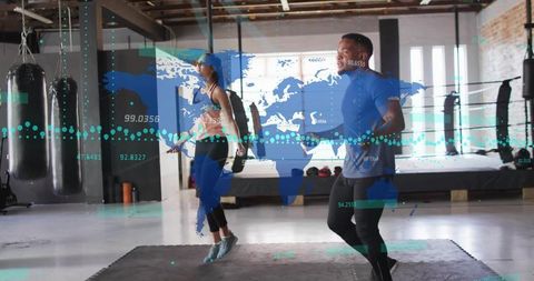 Partners Skipping Rope in Industrial Gym with World Map Data Overlay