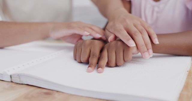 Close-up of Hands Reading Braille Text Together Indoors - Download Free Stock Images Pikwizard.com