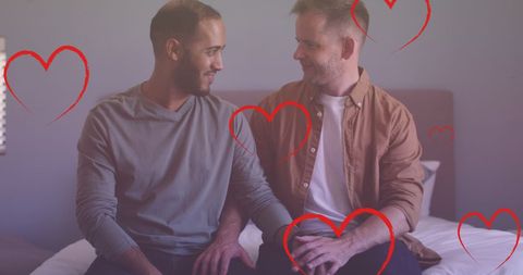 Diverse gay couple embracing with heart icons