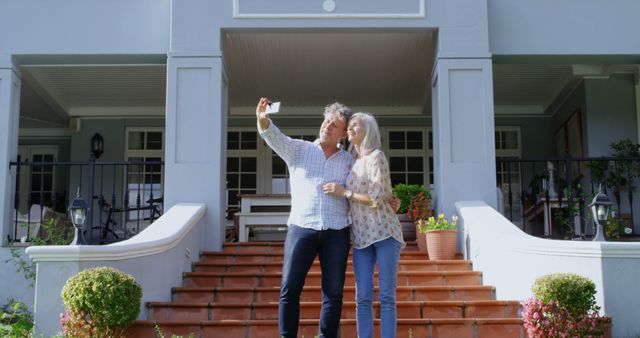 Smiling Senior Couple Taking Selfie in Front of House on Sunny Day - Download Free Stock Images Pikwizard.com