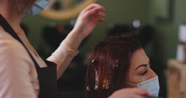 Hairdresser Highlighting Customer's Hair While Wearing Face Masks - Download Free Stock Images Pikwizard.com