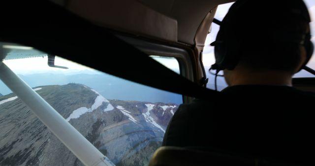 Pilot Flying Small Aircraft Over Snow-Capped Mountains - Download Free Stock Images Pikwizard.com