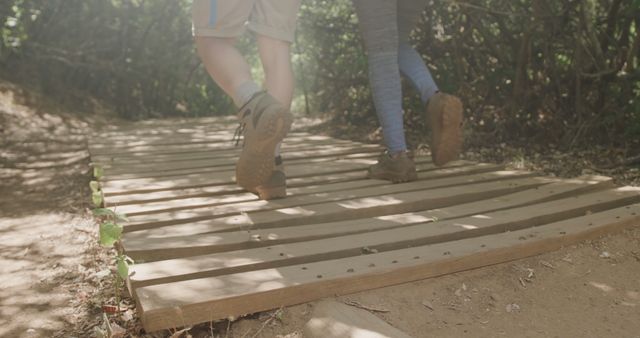 Hiking in Woods on Wooden Pathway, Feet of Hikers with Boots Seen from Rear View - Download Free Stock Images Pikwizard.com