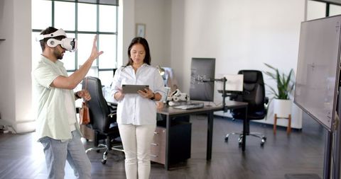 Business Team Collaborating on VR Technology in Contemporary Office