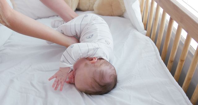 Parent playing with baby on bed in bright room - Download Free Stock Images Pikwizard.com