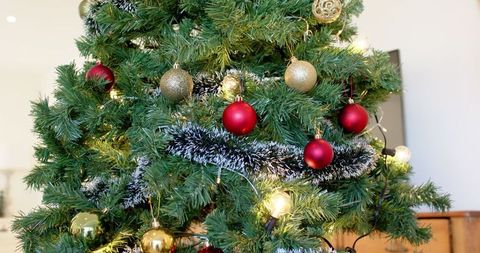 Festive Christmas Tree with Red and Gold Decor and Warm Lighting