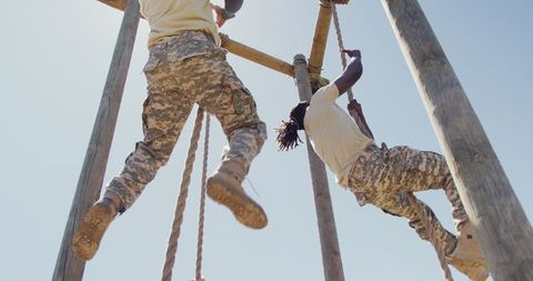 Soldiers conquering obstacle course in training