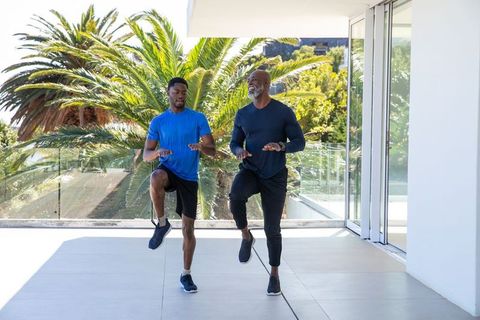 Father and Son Exercising on Balcony with Scenic View