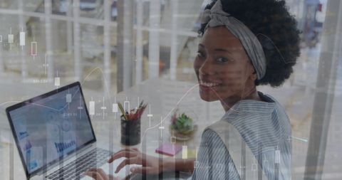 African American Woman Analyzing Financial Data on Laptop with Graph Overlays - Download Free Stock Images Pikwizard.com
