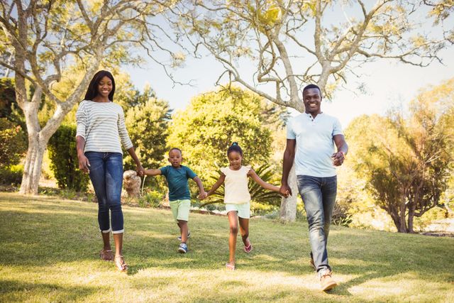 Family enjoying a sunny day in the park, walking hand in hand. Perfect for themes related to family bonding, outdoor activities, leisure time, and healthy lifestyle. Suitable for advertisements, family-oriented content, and lifestyle blogs.