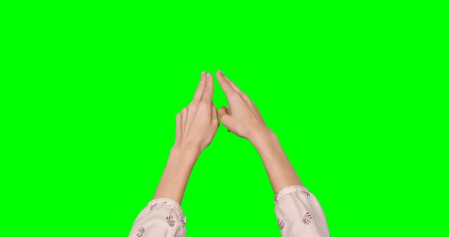 Hands of a woman gesturing with fingers touching on a green screen background. Ideal for adding custom content or adjusting for promotional uses, displaying hand movements, tutorials, or interactive visual presentations.