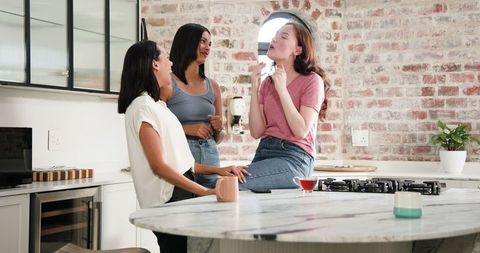 Friends Celebrating Engagement in Modern Kitchen Setting