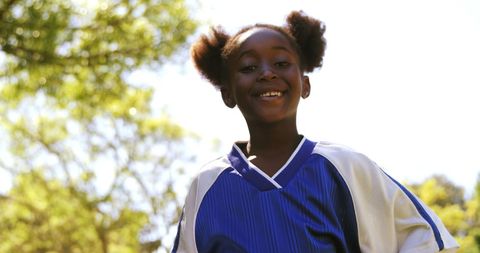 Joyful Girl Posing with Football in Morning Sunshine