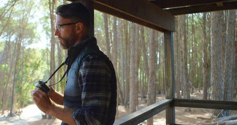 Man Observing Pine Forest from Viewing Deck in Wilderness