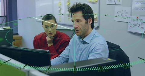 Innovative Team Collaboration Analyzing Data on Office Monitors