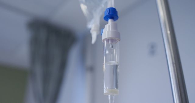 Close up view of dripping medicine in drip equipment working in hospital room. medicine, health and healthcare services.