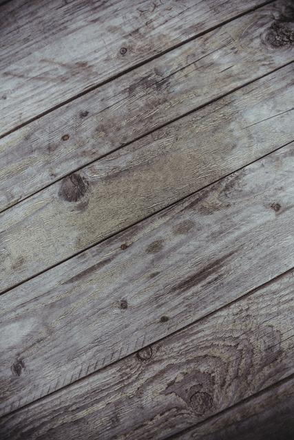 Rustic old wooden plank wall featuring weathered wood with visible grain and natural textures. Ideal for use as a background in design projects, presentations, or web design. Can also be used in promotional materials, interior design concepts, or product photography backdrops.