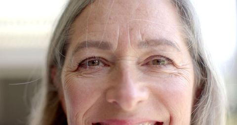 Joyful Senior Woman with Gray Hair and Blue Eyes Depicting Happiness