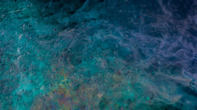 Vivid reflections on the tranquil sea surface create an abstract and calming visual. The interplay of teal and blue hues adds a peaceful yet artistic element. Ideal for use in interior design, meditation apps, and as a relaxing background.