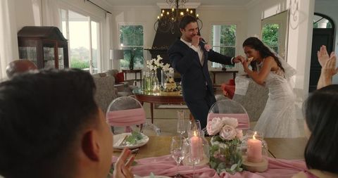 Joyful Couple Dancing at Elegant Wedding Reception in Cozy Home