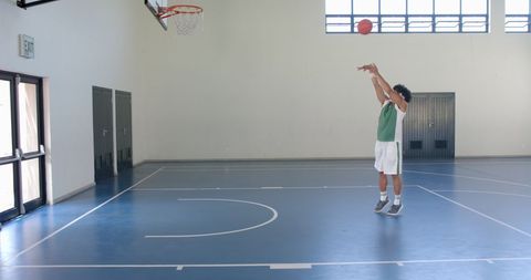 Athletic Young Man Practicing Basketball in School Gymnasium - Download Free Stock Images Pikwizard.com