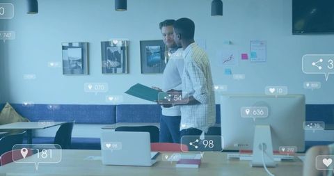Colleagues reviewing folder walking in coworking office with social media overlays