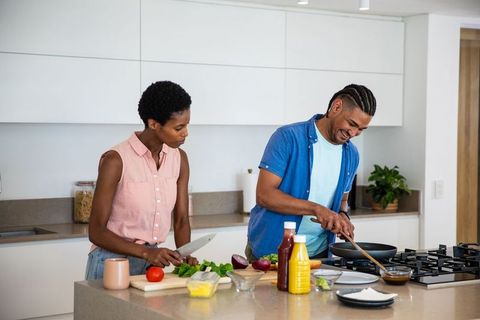 Diverse Couple in Modern Kitchen Cooking Together