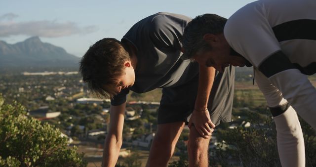 Senior caucasian father and adult son running outdoors stretching together in the sun - Download Free Stock Photos Pikwizard.com