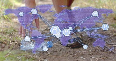 Crouching woman picking up plastic bottle on dirt trail while global network map overlaying