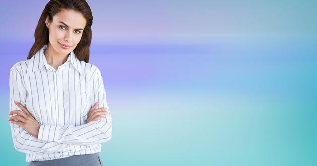 Female executive standing with arms crossed against colored background