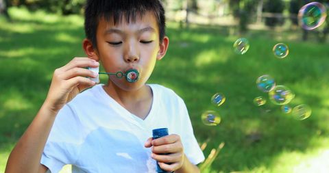 Child Blowing Soap Bubbles Outdoors on Sunny Day - Download Free Stock Images Pikwizard.com