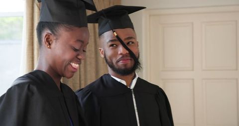 Joyful African American Couple Celebrating Graduation at Home