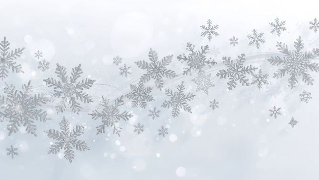 Drifting Silver Snowflakes on Pale Blue Bokeh Background for Winter Holiday Design