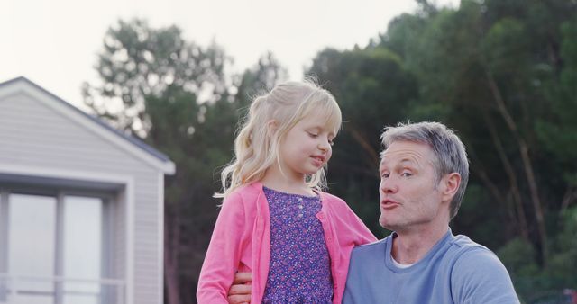 Father Holding Daughter Outdoors Near House - Download Free Stock Images Pikwizard.com