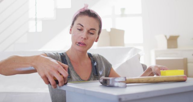 Focused Woman Measuring Furniture in Bright Indoor Space - Download Free Stock Images Pikwizard.com