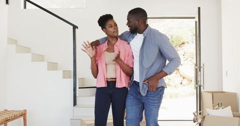Smiling Couple Embracing While Moving Into New Home