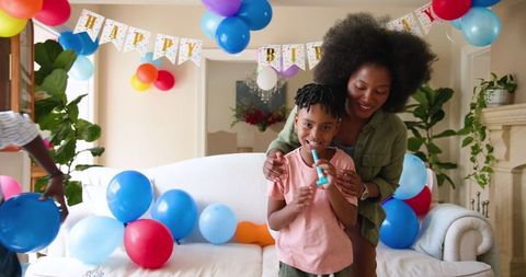 Mother and Son Celebrating Birthday with Joyful Decorations at Home