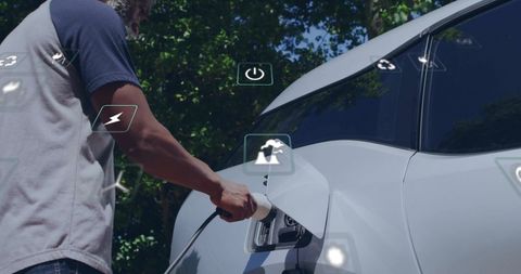 Man Charging Electric Car with Digital Eco Icons