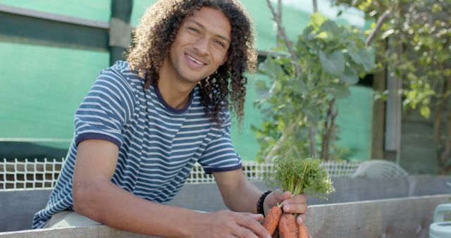 Young Man Smiling While Harvesting Fresh Carrots in Community Garden - Download Free Stock Images Pikwizard.com