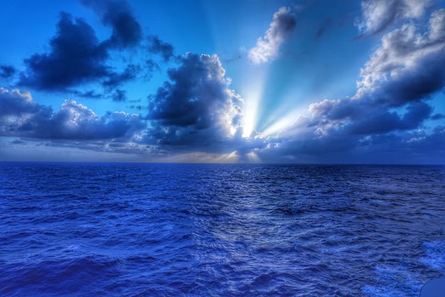 Majestic Ocean Sunset with Dramatic Sky and Sunbeams - Download Free Stock Photos Pikwizard.com